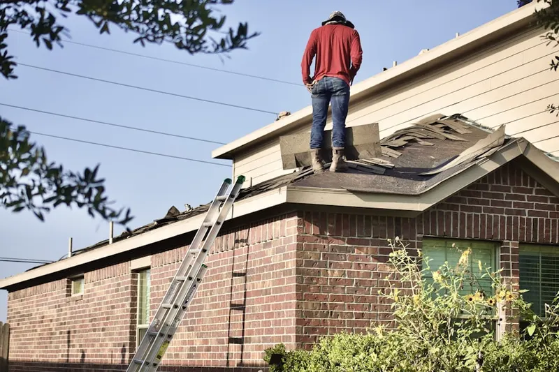 Professional roofer working on a residential roof in Baileyville
